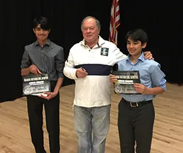 Two contestants taking a photo with Dr. Soifer.